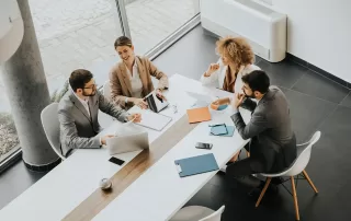 A group of people in an office setting, discussing finances with a tax accountant.