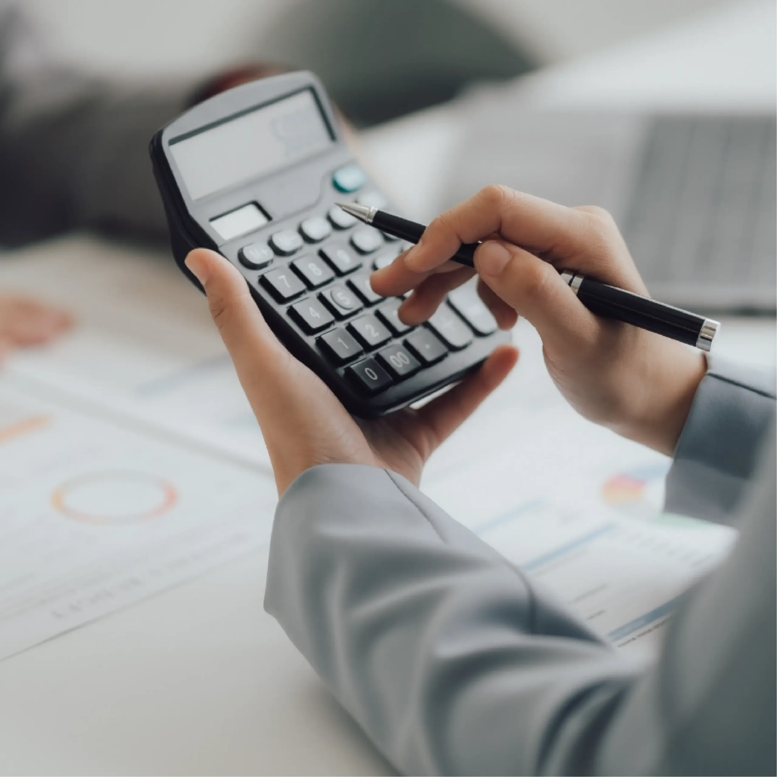 A person uses a calculator to crunch some numbers.